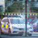 UK riots August 2024, police car in front of a damaged office block in Sunderland