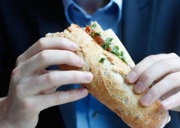 Nutrition, man eating at work, health, wellbeing, preventative